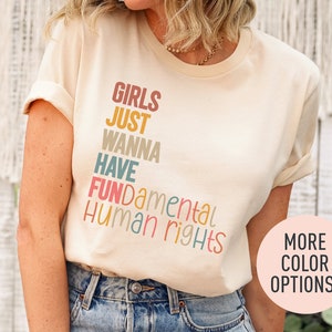 a woman wearing a t - shirt that says girls just wanna have human rights