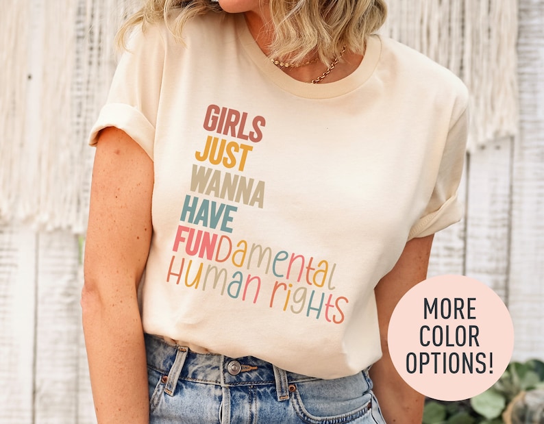 a woman wearing a t - shirt that says girls just wanna have human rights