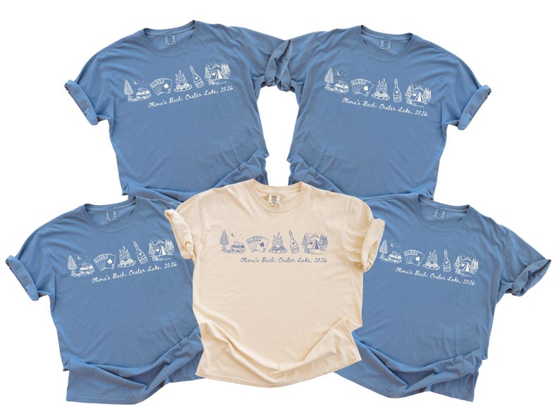five blue t-shirts with white text and graphics, and one beige t-shirt, all of which appear to be part of a collection or merchandise.