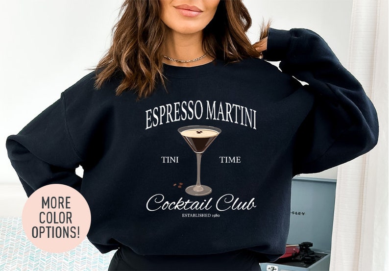 a woman wearing a black sweatshirt that says espresso martini time cocktail club