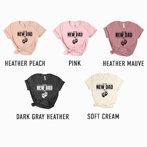 a group of t - shirts that say new dad, new dad, pink,