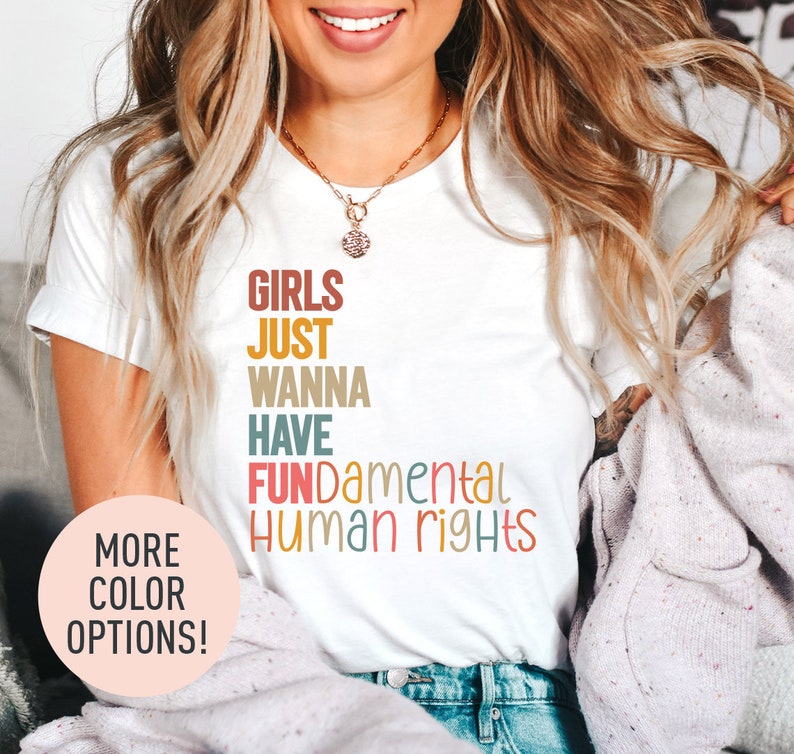a woman wearing a t - shirt that says girls just wanna have fundamental human rights