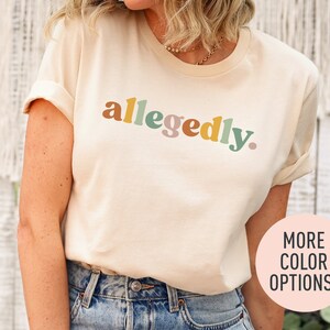 a woman wearing a tee shirt with the word'allegdy'printed on