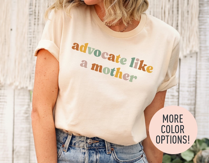 a woman wearing a t - shirt that says, adocate like a mother