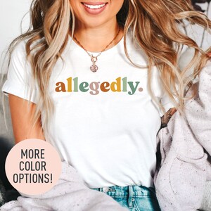 a woman wearing a white shirt with the word algedy on it