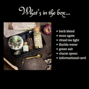 May include: A black metal box with a variety of items for a green witch ritual. The box contains a small glass jar of dried herbs, a small bottle of oil, a tea light candle, a small bottle of water, a green stone, a charm spoon, and an informational card. The card reads "Green Witch mullein garden sage raspberry leaf calendula".