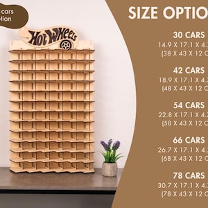 May include: A light-coloured wooden display rack with multiple horizontal shelves for toy cars, featuring a Hot Wheels logo at the top. The text lists size options for 30, 42, 54, 66, and 78 cars with dimensions in centimetres ranging from 38 to 78 cm wide.