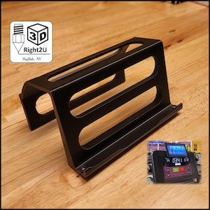 May include: A black 3D-printed plastic stand with a rectangular base and two horizontal cutouts on the side panels. The stand features a logo with a 3D cube icon and the text 3D Right2U Buffalo, NY. An inset shows the stand mounted on a treadmill.