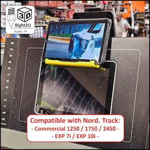May include: A bright yellow plastic tablet holder mounted on a black treadmill console. The holder supports a tablet displaying a car drifting on a track. Text on the console reads: Compatible with Nord. Track: - Commercial 1250 / 1750 / 2450 - EXP 7i / EXP 10i -.
