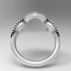 May include: Silver ring with a textured band and a smooth, rounded top. The ring is marked "925" on the inside.
