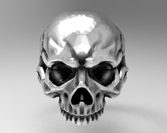 May include: A silver skull ring with a detailed design. The skull has a menacing expression with deep-set eyes and a prominent jawline.