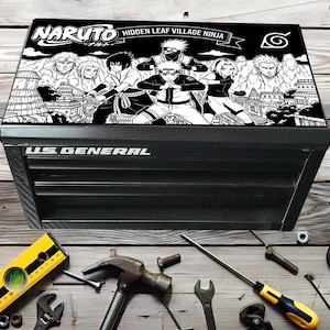 May include: Black US General tool chest with a Naruto graphic on the lid. The graphic features black and white anime characters and the text "Naruto Hidden Leaf Village Ninja". Tools like a level, hammer, and wrench are scattered around the chest.