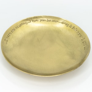 May include: A small, oval brass dish with a raised rim. The dish has engraved text around the edge: "...21 years and counting...I love you forever...Greg & Erin March 3, 2003."