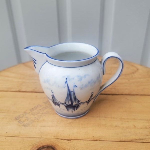 Blue Delft Creamer Pitcher With Sail Boats Made In Germany. It Measures 5-1/4" Handle To Spout x 3-1/4"W x 3-3/4"H.