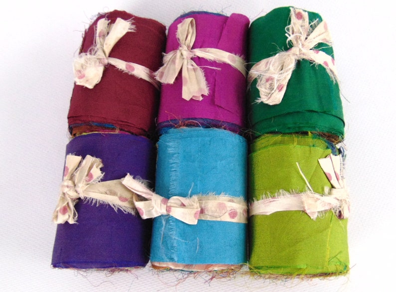 Sari silk rolls multicolour. Recycled silk fabric from India.