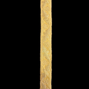 May include: A gold trim with a repeating pattern of small floral designs.