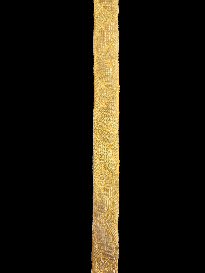 May include: A gold trim with a repeating pattern of small floral designs.