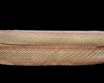 May include: Two pieces of gold and red trim with a chevron pattern. The trim is about 1 inch wide.