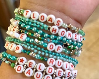 TS The Life Of A Showgirl Inspired Bracelets | Orange letters with green/blues beads