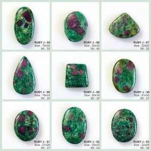 May include: A collection of nine polished ruby in zoisite gemstones in various shapes including oval, teardrop, and rectangular. Each stone features a vibrant green base with deep red inclusions. Text labels identify each piece from RUBY J-85 to RUBY J-93 with specific dimensions in millimetres and weight in carats.