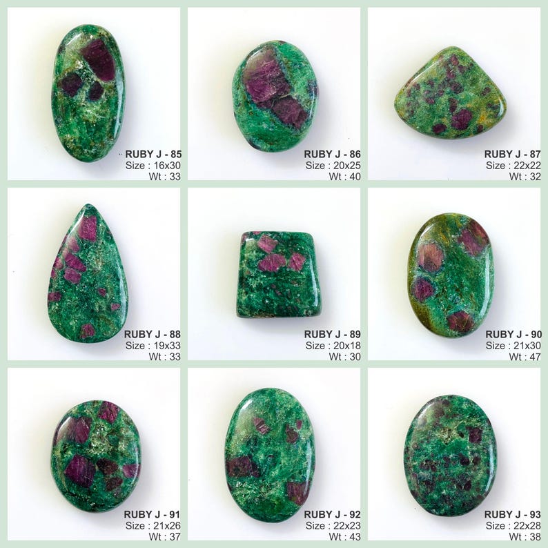 May include: A collection of nine polished ruby in zoisite gemstones in various shapes including oval, teardrop, and rectangular. Each stone features a vibrant green base with deep red inclusions. Text labels identify each piece from RUBY J-85 to RUBY J-93 with specific dimensions in millimetres and weight in carats.