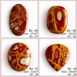 May include: Four polished, oval-shaped gemstones with a mix of red, yellow, and white patterns. Each stone has a unique design and is labeled with a size in inches and weight in ounces. The gemstones are displayed against a pink background.