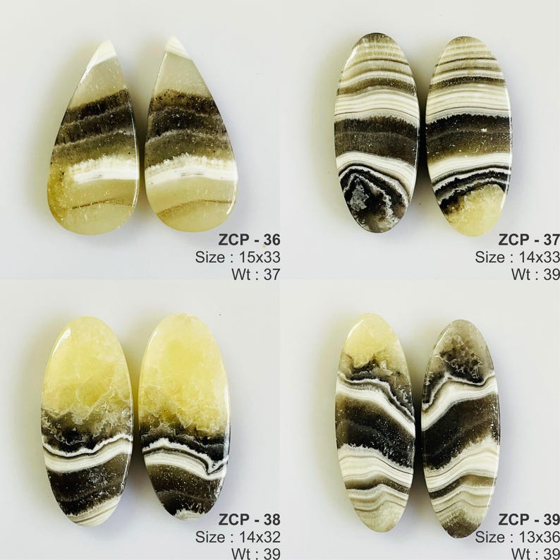 May include: Four pairs of polished gemstone cabochons in various shapes. The stones feature a mix of beige, brown, and white banding. Each pair is labeled with a size in millimeters and weight in grams.