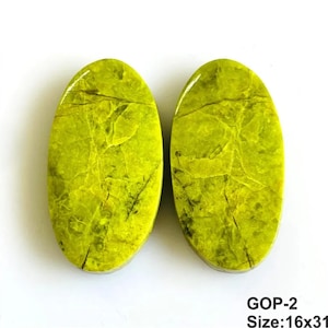 May include: Two oval-shaped, lime green gemstones with a natural, cracked, and veined texture throughout the surface. The stones are labelled with the text GOP-2 and Size:16x31, indicating their specific identification and dimensions in millimetres.