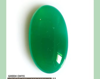 May include: A smooth, polished, oval-shaped green onyx gemstone with a vibrant, solid emerald hue and a reflective surface. The image includes the text "GREEN ONYX" and "NEXT TO SEE MORE OPTIONS" with two vertical bars at the bottom of the frame.