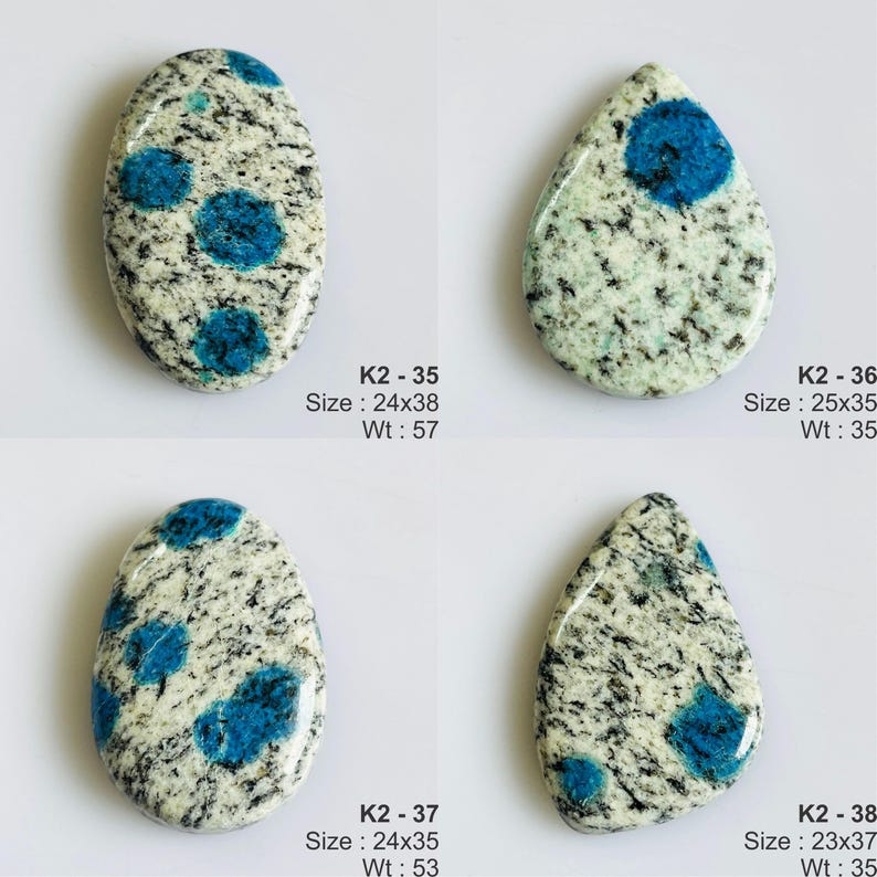 May include: Four polished K2 stone cabochons with white and grey granite-like speckled patterns and vibrant blue circular inclusions. Each piece is labeled with codes K2-35, K2-36, K2-37, and K2-38, including dimensions in mm and weight in carats.