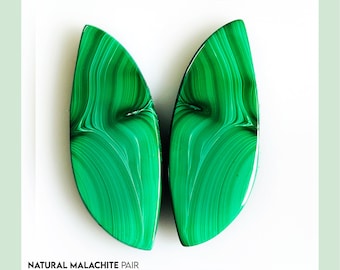 May include: A pair of polished green malachite stones with distinctive swirling patterns. The stones are set against a white backdrop, with text at the bottom reading "NATURAL MALACHITE PAIR NEXT TO SEE MORE OPTIONS".