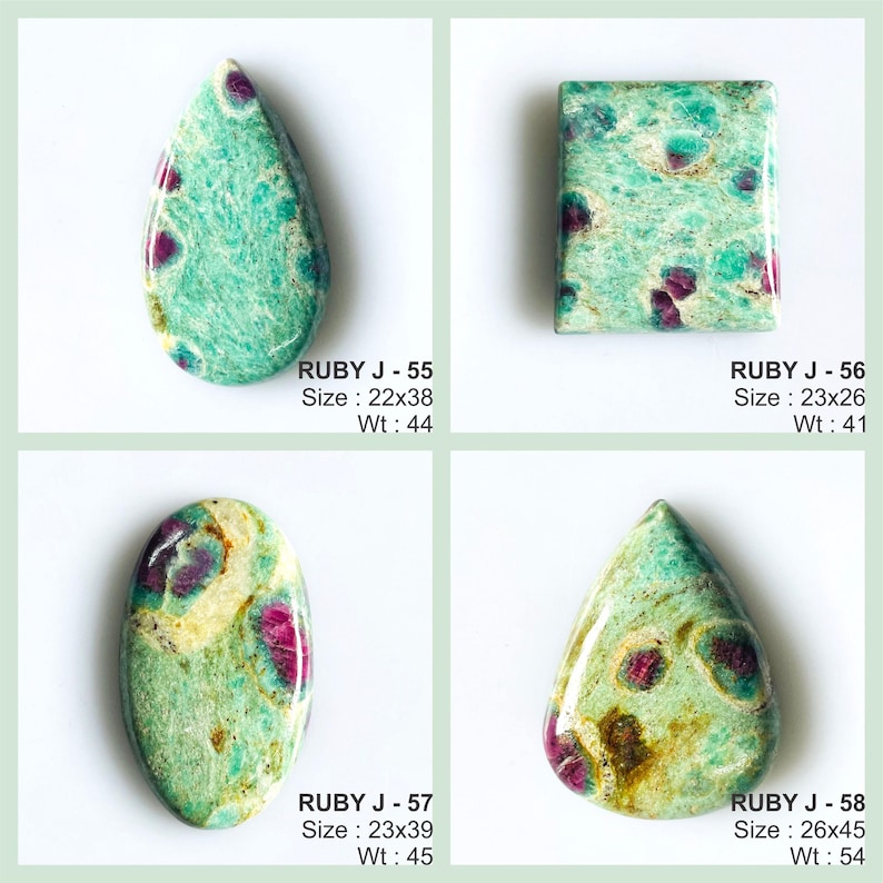 May include: Four polished cabochon gemstones featuring a mix of green and teal matrix with embedded magenta ruby inclusions. Each stone is labelled with a code, size in mm, and weight in carats: Ruby J-55 (22x38mm, 44ct), J-56 (23x26mm, 41ct), J-57 (23x39mm, 45ct), and J-58 (26x45mm, 54ct).