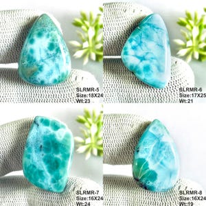 May include: Four polished Larimar gemstones in shades of turquoise and white with unique marbling patterns. Each stone is labeled with codes SLRMR-5, SLRMR-6, SLRMR-7, and SLRMR-8, including dimensions in mm and weight in carats for each individual piece.