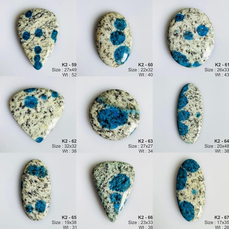 May include: A collection of nine polished K2 granite cabochons featuring a speckled white and grey base with distinct circular blue azurite inclusions. Each stone is labeled with a reference code, dimensions in millimeters, and weight in carats.
