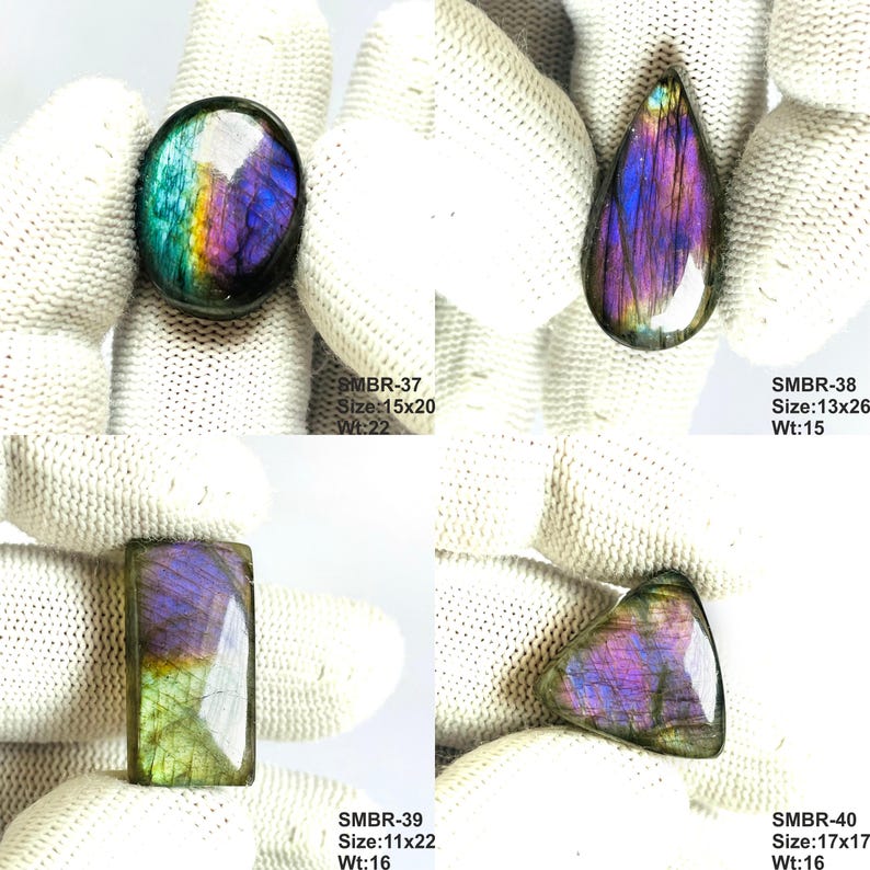 May include: Four polished labradorite gemstones in various shapes: oval, teardrop, rectangular, and triangular. The stones display iridescent colors of blue, purple, and green. The oval stone is 15x20 mm and weighs 22. The teardrop is 13x26 mm and weighs 15.