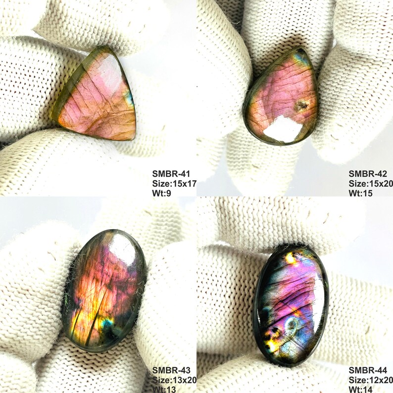 May include: Four polished labradorite gemstones in various shapes. The stones display iridescent colors of pink, purple, and gold. Each stone has a unique shape and size, with the largest measuring 15x20 mm. The image includes text indicating the size and weight of each stone.