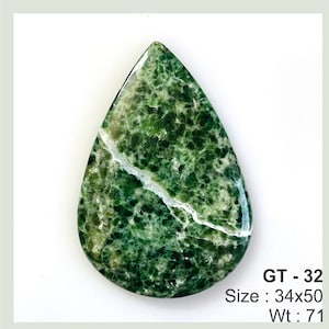 May include: A green and white teardrop-shaped cabochon gemstone with a mottled pattern. GT - 32 Size: 34x50 Wt: 71