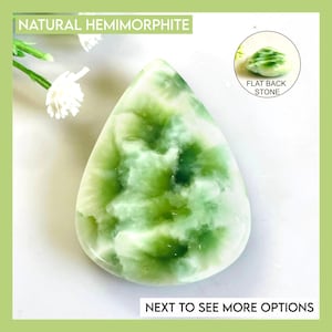 May include: A teardrop-shaped natural hemimorphite stone featuring a marbled pattern of white and various shades of green. The stone has a smooth, polished surface. An inset circle shows the side profile labelled FLAT BACK STONE.