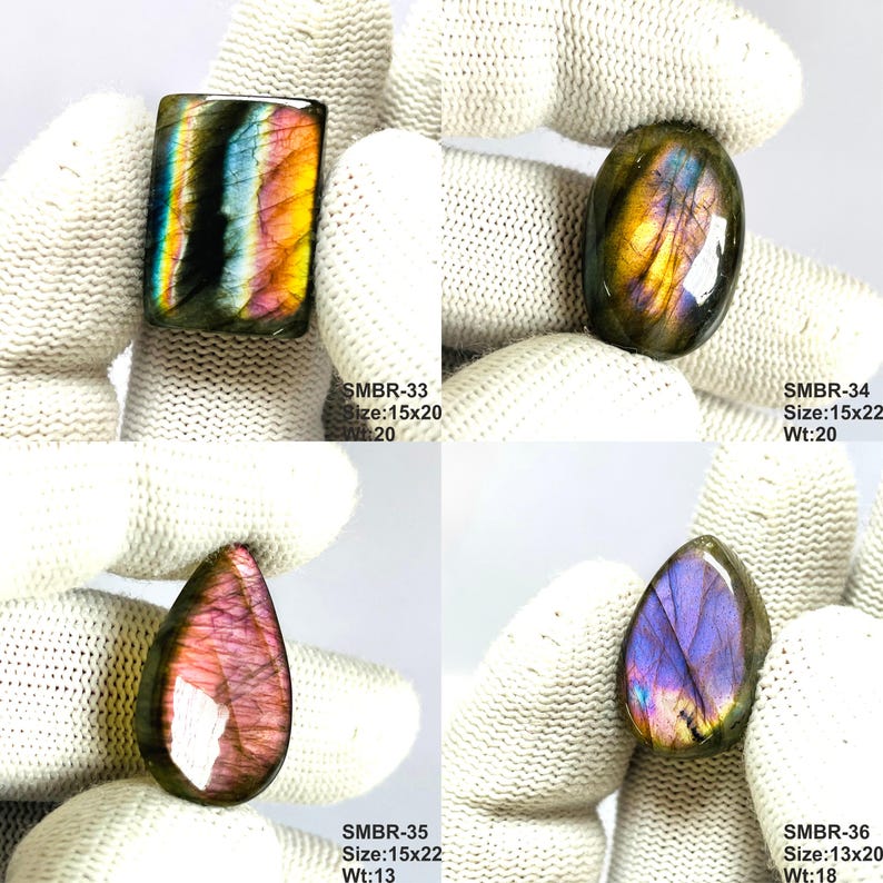May include: Four polished labradorite gemstones in various shapes. The stones display iridescent colors including blue, purple, yellow, and pink. Each stone is held by a gloved hand. The text on the image indicates sizes and weights.