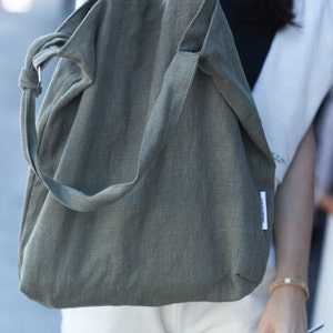 Urban French natural linen hobo crossbody bag featuring top handles, an internal zip pocket and an adjustable shoulder strap image 10