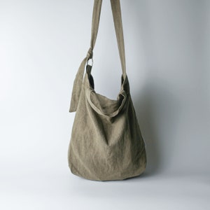 Urban French natural linen hobo crossbody bag featuring top handles, an internal zip pocket and an adjustable shoulder strap