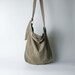 Urban French natural linen hobo crossbody bag featuring top handles, an internal zip pocket and an adjustable shoulder strap 