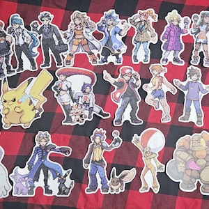 Puede incluir: Una colección de pegatinas de dibujos animados coloridos con personajes de la serie de videojuegos Pokémon. Las pegatinas están impresas en papel blanco y tienen un acabado brillante.