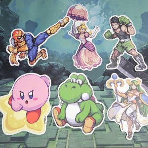 May include: A set of ten colorful vinyl stickers featuring characters from popular video games. The stickers include Mario, Luigi, Peach, Bowser, Donkey Kong, Yoshi, Kirby, Link, Samus Aran, and Pikachu. Each sticker is approximately 2 inches in diameter.