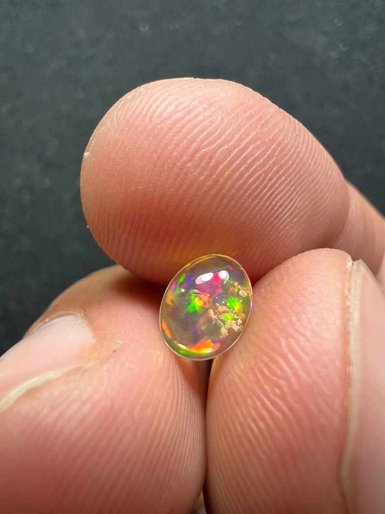 Amazing fire opal with its beautiful sparkles and quarry inlay AAA quality weight 0.65 carats measure 7.5x6x3mm image 9