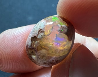 Amazing fire opal on matrix with its beautiful sparkles and landscapes AAA quality weight 10.10 carats measure 16.5x12x8mm Contraluz