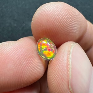 Amazing fire opal with its beautiful sparkles and quarry inlay AAA quality weight 0.65 carats measure 7.5x6x3mm image 1