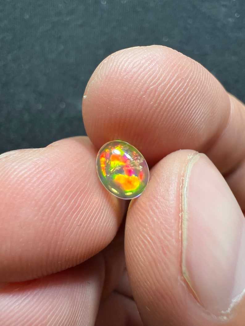Amazing fire opal with its beautiful sparkles and quarry inlay AAA quality weight 0.65 carats measure 7.5x6x3mm image 1