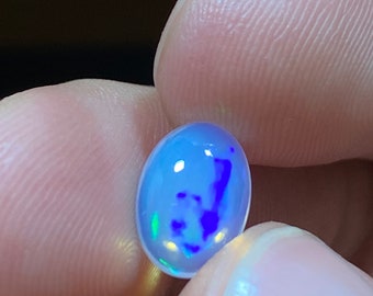 Incredible opal with its beautiful flashes of blues and greens AA quality weight 2.05 carats measure 10.5x7.5x4.5xmm