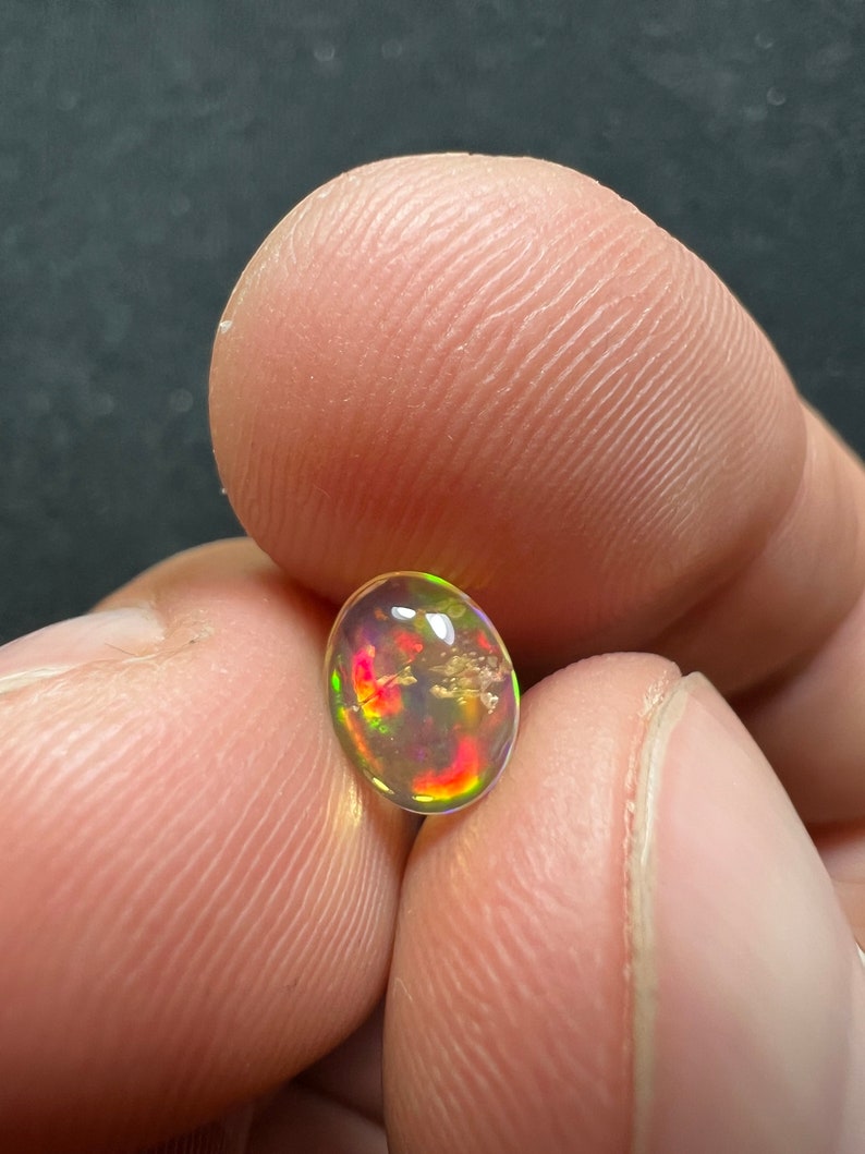 Amazing fire opal with its beautiful sparkles and quarry inlay AAA quality weight 0.65 carats measure 7.5x6x3mm image 7